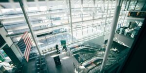 A bright, modern airport terminal representing international mobility and retirement planning.