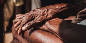 A close-up of senior hands in soft natural sunlight.