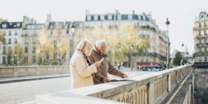An active senior couple checking a map in an airport terminal.