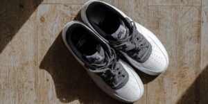 A pair of supportive walking shoes placed on a hardwood floor, symbolizing foot health and stability for seniors.