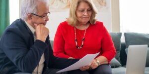 A senior couple reviewing financial documents for retirement planning.