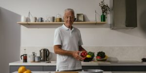 A healthy senior couple preparing a nutritious meal in a bright kitchen.