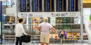 A senior couple planning their international trip in an airport terminal.