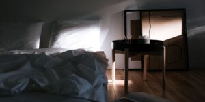 A peaceful and organized bedroom setting bathed in soft morning light, representing restorative sleep.