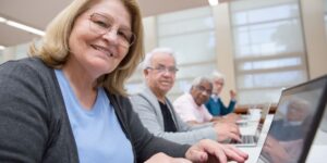 A group of seniors learning about digital accessibility in a community workshop.