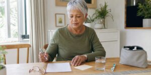Older adult preparing a medicine list before a dental visit