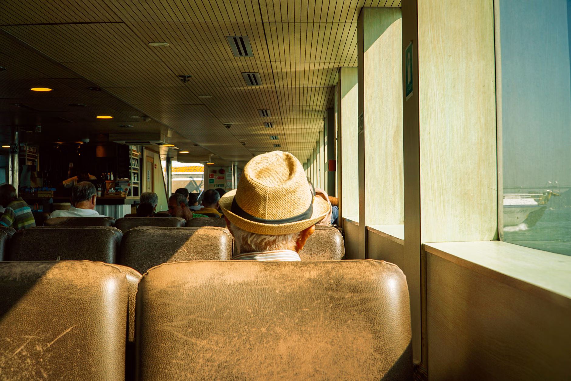 A senior traveler resting comfortably on transit with essential gear.