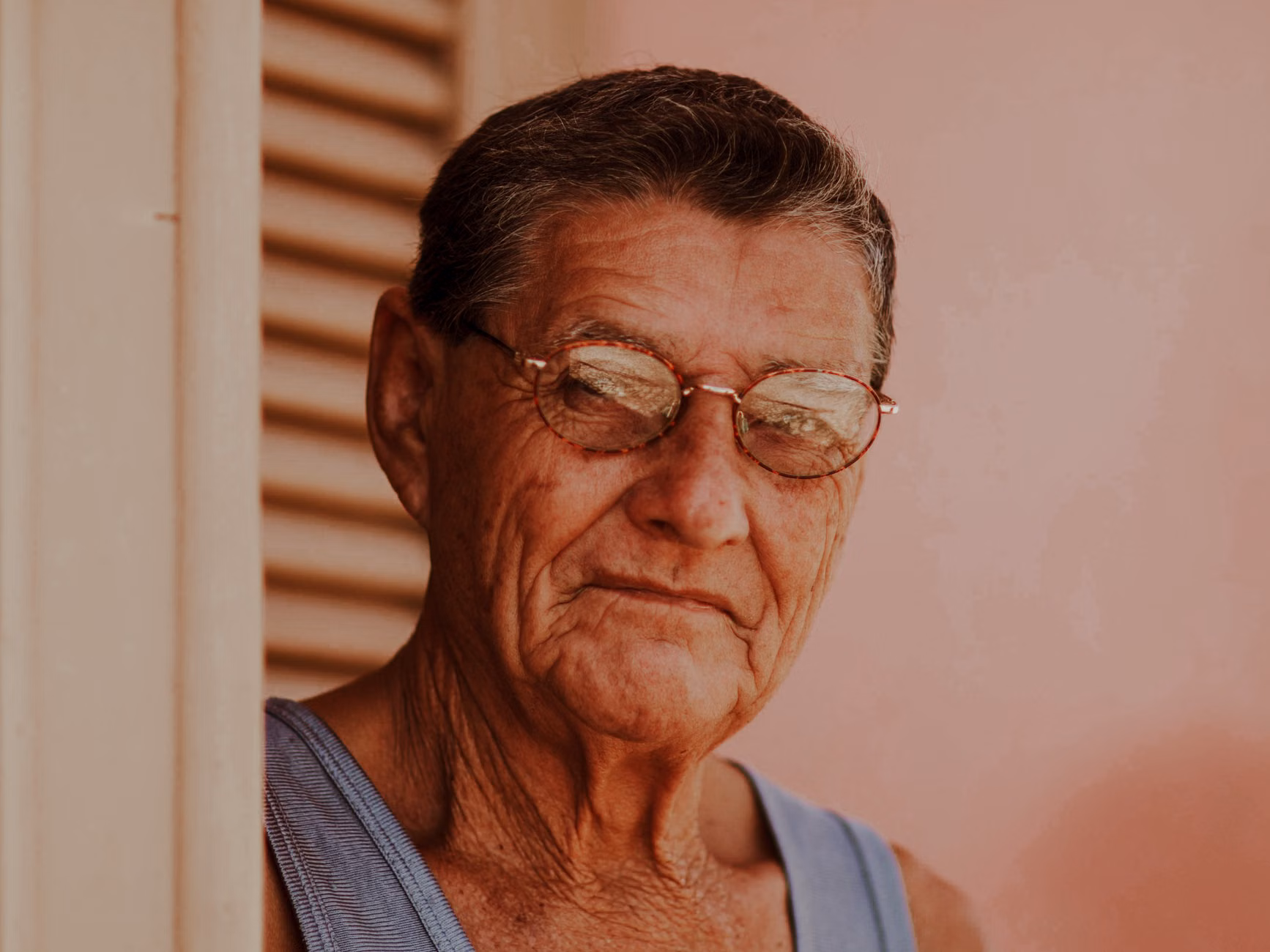 An older adult performing a gentle, controlled neck rotation.