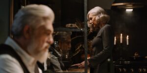 An elegant senior couple enjoying classical music in a cozy, well-lit living room.