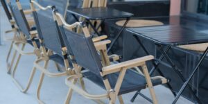 A sturdy and comfortable portable chair set up in a sunny park.