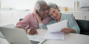 A senior couple reviewing financial documents for retirement planning.