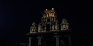An ancient stone temple illuminated by the golden rays of the rising sun.