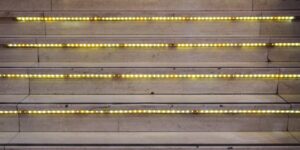 A safe, well-lit staircase with high-contrast safety strips, designed for senior accessibility.