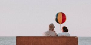 An elderly couple enjoying the view from a scenic train ride.
