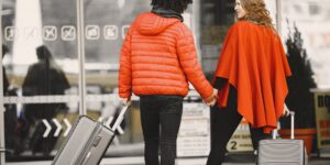 A happy senior couple walking through an airport terminal without luggage.