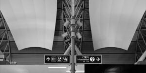 A modern, accessible public transport hub with clear, large-font signage for older adults.