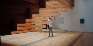 An elderly couple exploring a spacious, accessible modern museum gallery.