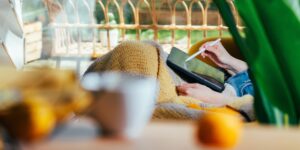 A cozy evening scene with a person using a tablet with warm, eye-friendly lighting.