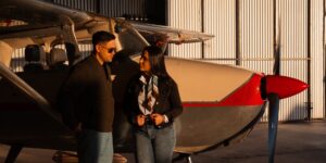 A senior couple looking at planes from a modern airport terminal.