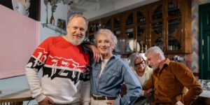 A group of happy seniors in a community setting representing healthy aging.