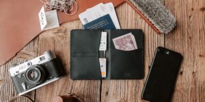 A travel kit, passport, and boarding pass on a wooden table representing organized senior travel.