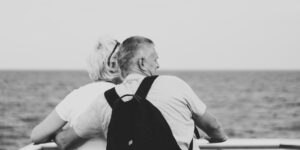 A senior couple enjoying the ocean view from a cruise ship balcony.