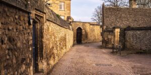 A serene European village street with cobblestones and historic architecture.