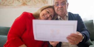 A senior couple reviewing their digital health records on a tablet in a modern home.