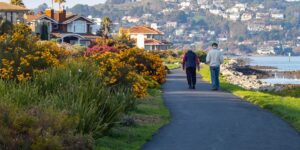 A senior couple walking along an accessible path toward a historical monument.