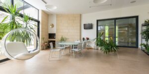 A serene living room filled with indoor plants, creating a calming environment for a senior.