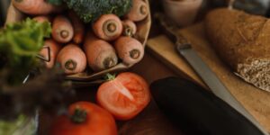 A vibrant assortment of whole grains, fruits, and vegetables on a wooden table representing a fiber-rich diet.