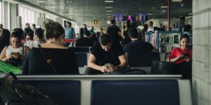 A senior couple checking their smartphone in an airport terminal.
