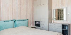 A peaceful and organized bedroom bathed in soft morning light, representing a restful environment for seniors.