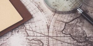 A workspace featuring an old map and research tools, symbolizing the start of a historical project.