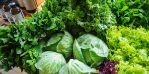A healthy plate of green vegetables representing a vitamin-K-rich diet.