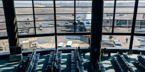A peaceful, modern airport terminal lounge with seniors preparing for travel.