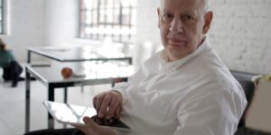 A senior individual safely managing digital finances on a tablet in a well-lit environment.