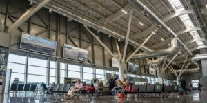 A serene and modern airport departure lounge with floor-to-ceiling windows.