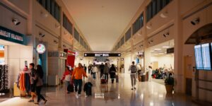 A peaceful, modern airport terminal lounge with senior travelers resting as the sun sets.