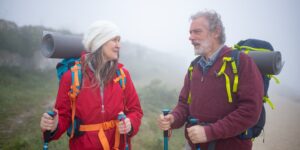 An active senior couple planning their walking tour in a historic city.