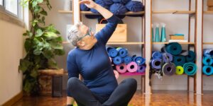 A senior adult practicing gentle seated exercises in a comfortable living room.