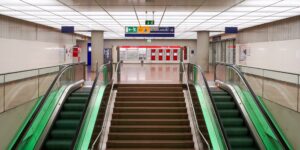 A clean, modern train station with high-contrast, accessible signage designed for universal use.