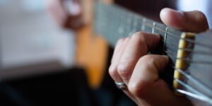 An older person practicing gentle finger-tapping exercises to improve dexterity.
