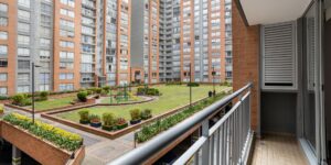 A modern, multi-generational housing complex with a shared garden.