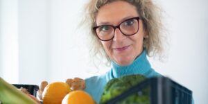 Healthy vegetables and reading glasses representing eye health and nutrition.