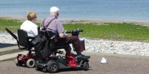 An elderly couple admiring a historic cathedral on an accessible, paved plaza.