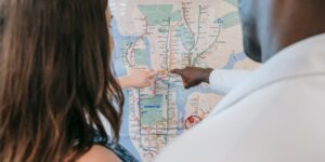 An older couple reviewing a transit map on a modern, accessible station platform.