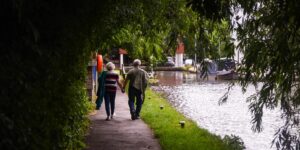 A senior couple enjoying a stroll through a spacious and accessible outdoor market.