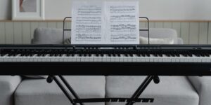A peaceful home music study setup with a piano and open music theory book.