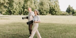 An active senior couple walking in a park, representing healthy joint management.